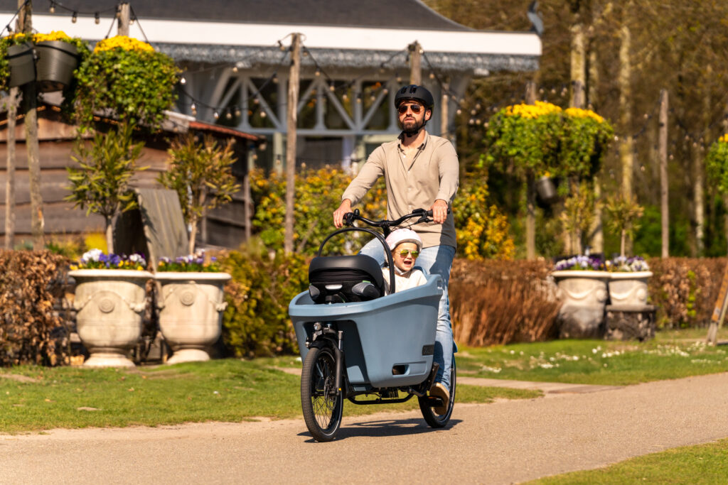 Father and daughter cycling with their colourful Dolly Joy
